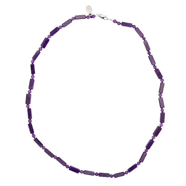 Purple beaded necklace on a white background