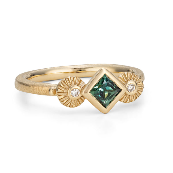 Gold ring with a green gemstone on a white background