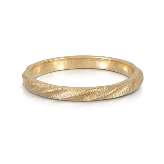 Gold ring with a textured band on a white background